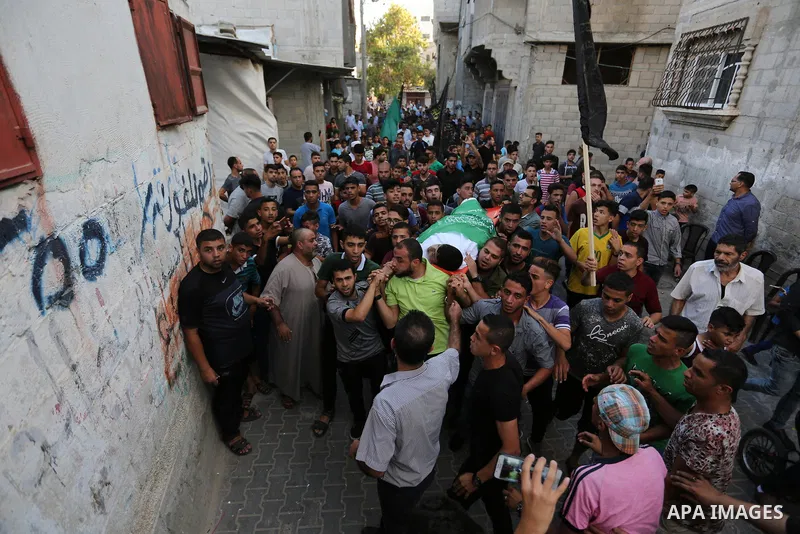 Mourners carry the body of Palestinian of Zakaria Beshbesh, 13, who died of his wounds endured during clashes with Israeli troops in a tent city protest where Palestinians demand the right to return to their homeland at...