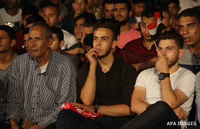 Palestinians watch on a big screen the Russia 2018 World Cup Group A football match between Russia and Egypt at seaport in Gaza city on June 19, 2018. Russia won 3-1. Photo by Mahmoud Ajour