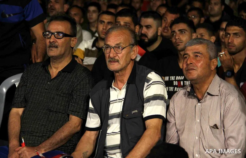 Palestinians watch on a big screen the Russia 2018 World Cup Group A football match between Russia and Egypt at seaport in Gaza city on June 19, 2018. Russia won 3-1. Photo by Mahmoud Ajour