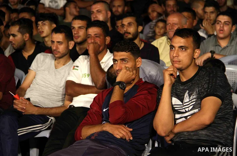 Palestinians watch on a big screen the Russia 2018 World Cup Group A football match between Russia and Egypt at seaport in Gaza city on June 19, 2018. Russia won 3-1. Photo by Mahmoud Ajour