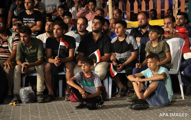 Palestinians watch on a big screen the Russia 2018 World Cup Group A football match between Russia and Egypt at seaport in Gaza city on June 19, 2018. Russia won 3-1. Photo by Mahmoud Ajour