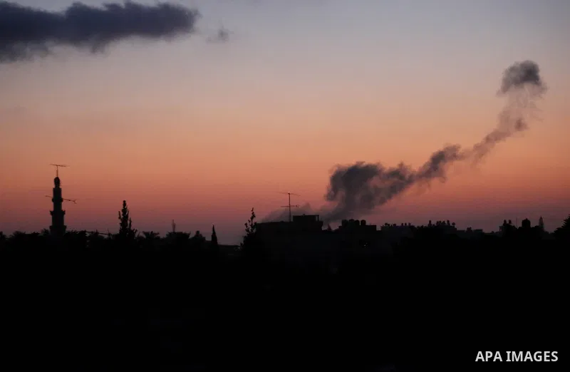 A picture taken from Khan Younis town in the southern Gaza Strip on June 20, 2018, shows a smoke billowing in the background following an Israeli air strike on the Palestinian enclave. Photo by Ashraf Amra