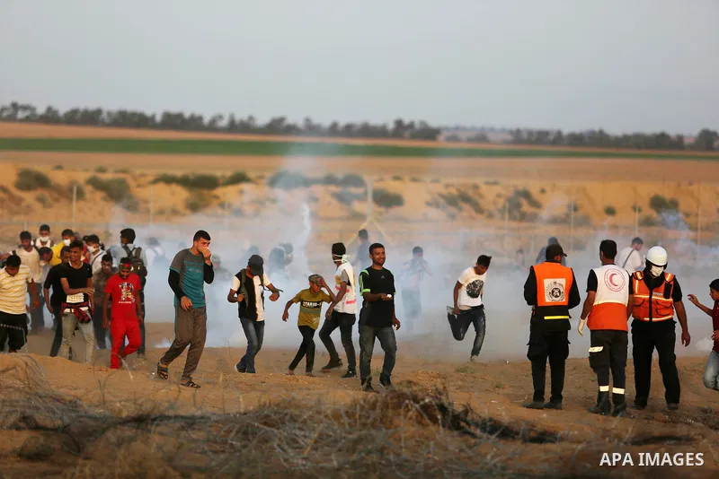 Palestinian protesters gather during clashes with Israeli troops in tents protest where Palestinian demand the right to return to their homeland at the Israel-Gaza border, in Khan Younis in the southern of Gaza Strip on...