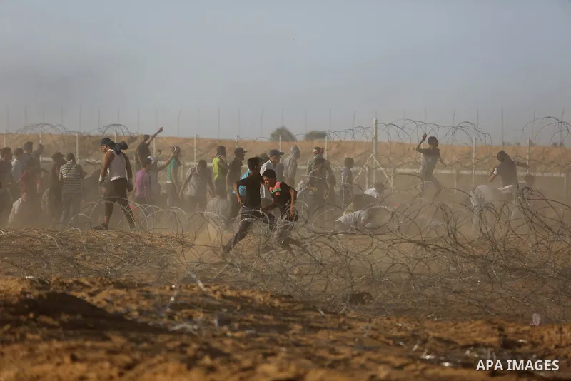 Palestinian protesters gather during clashes with Israeli troops in tents protest where Palestinian demand the right to return to their homeland at the Israel-Gaza border, in Khan Younis in the southern of Gaza Strip on...