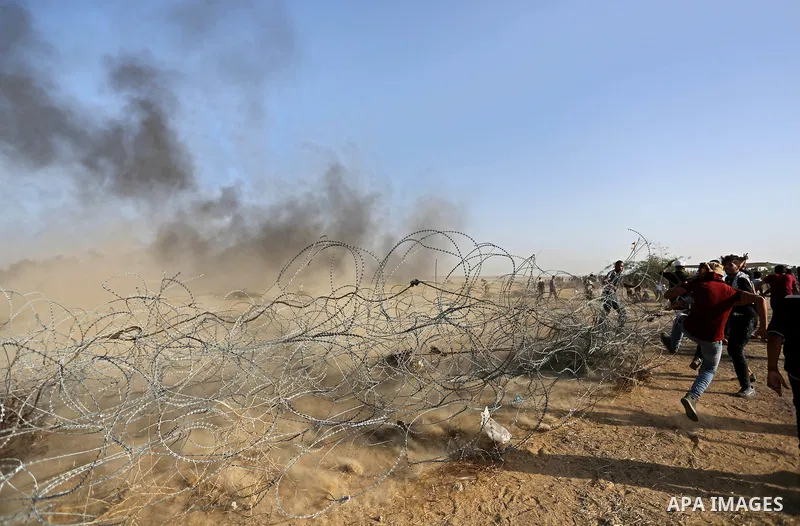 Palestinian protesters gather during clashes with Israeli troops in tents protest where Palestinian demand the right to return to their homeland at the Israel-Gaza border, in Khan Younis in the southern of Gaza Strip on...