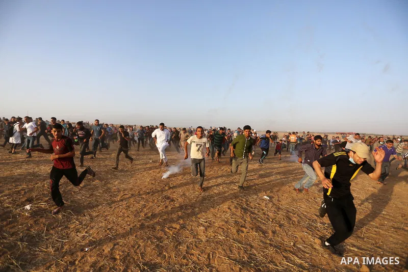 Palestinian protesters gather during clashes with Israeli troops in tents protest where Palestinian demand the right to return to their homeland at the Israel-Gaza border, in Khan Younis in the southern of Gaza Strip on...