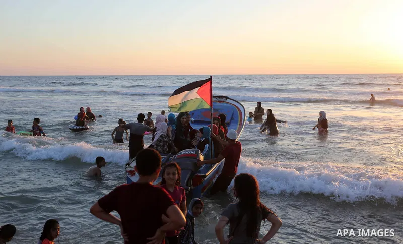 Palestinians enjoy their time off the coast of Gaza City sea during summer holiday on June 23, 2018. Photo by Ashraf Amra