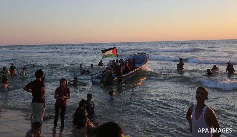 Palestinians enjoy their time off the coast of Gaza City sea during summer holiday on June 23, 2018. Photo by Ashraf Amra