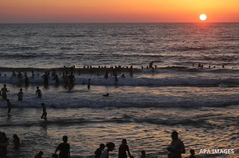 Palestinians enjoy their time off the coast of Gaza City sea during summer holiday on June 23, 2018. Photo by Ashraf Amra
