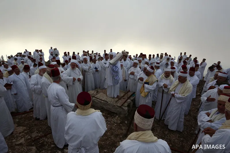 Samaritan worshipers pray on the top of Mount Gerizim in a traditional pilgrimage to mark the Shavuot's holiday at dawn near the West Bank city of Nablus June 24, 2018 which is giving of the Torah at Mount Sinai seven we...