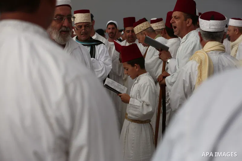 Samaritan worshipers pray on the top of Mount Gerizim in a traditional pilgrimage to mark the Shavuot's holiday at dawn near the West Bank city of Nablus June 24, 2018 which is giving of the Torah at Mount Sinai seven we...