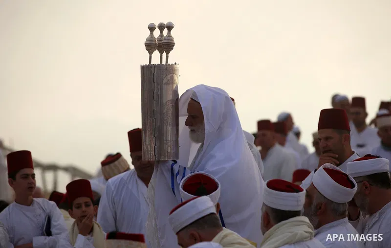 Samaritan worshipers pray on the top of Mount Gerizim in a traditional pilgrimage to mark the Shavuot's holiday at dawn near the West Bank city of Nablus June 24, 2018 which is giving of the Torah at Mount Sinai seven we...