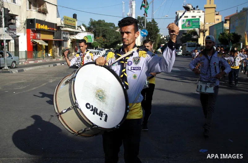 Palestinian scouts take part in a march marking the Palestinian Olympic Day, in Gaza city, on June 24, 2018. Photo by Bashar Zakri