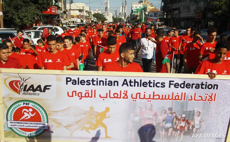 Palestinian scouts take part in a march marking the Palestinian Olympic Day, in Gaza city, on June 24, 2018. Photo by Bashar Zakri