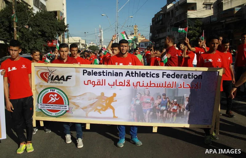 Palestinian scouts take part in a march marking the Palestinian Olympic Day, in Gaza city, on June 24, 2018. Photo by Bashar Zakri