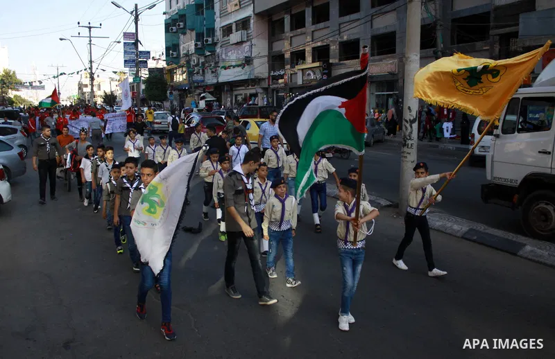 Palestinian scouts take part in a march marking the Palestinian Olympic Day, in Gaza city, on June 24, 2018. Photo by Bashar Zakri