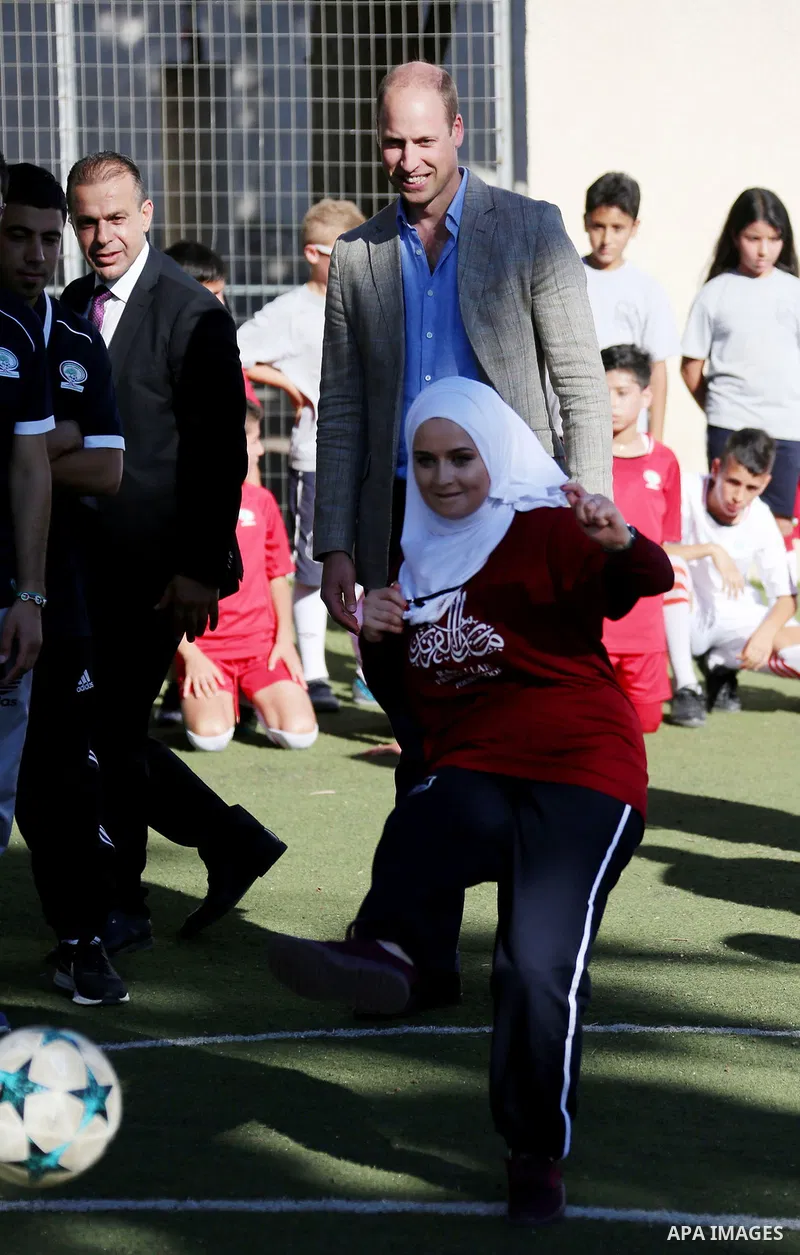 Britain's Prince William visits young Palestinian football players in the West Bank city of Ramallah on June 27, 2018. The Duke of Cambridge is the first member of the royal family to make an official visit to the Jewish...