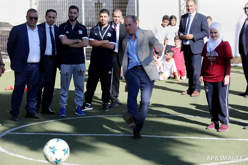 Britain's Prince William shoots a football during his meeting with young Palestinian football players in the West Bank city of Ramallah on June 27, 2018. The Duke of Cambridge is the first member of the royal family to m...