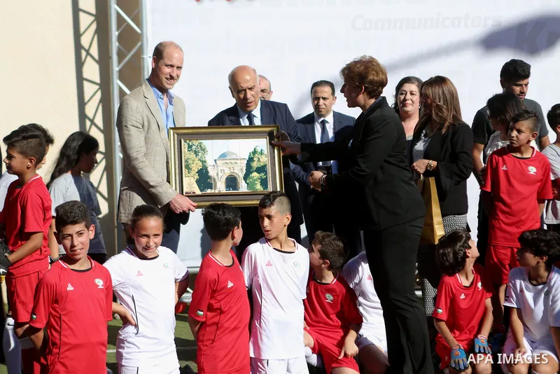 Head of the Palestinian Football Federation, Jibril Rajoub, honors Britain's Prince William in the West Bank city of Ramallah on June 27, 2018. The Duke of Cambridge is the first member of the royal family to make an off...