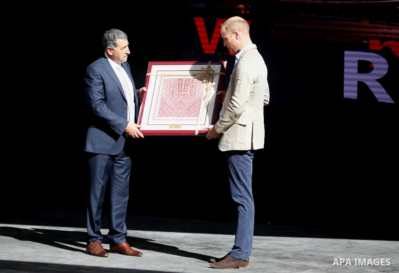 Britain's Prince William receives a gift from Musa Hadid, the mayor of Ramallah, at a reception during his visit to the West Bank city's municipality on June 27, 2018. The Duke of Cambridge is the first member of the roy...