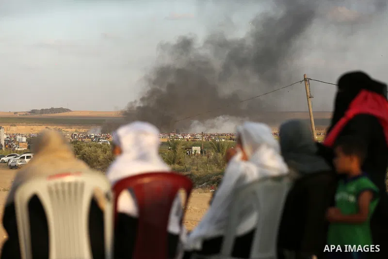 Palestinian women watch clashes between Palestinian protesters and Israeli troops in tents protest where Palestinian demand the right to return to their homeland at the Israel-Gaza border, in east of Gaza City on June 29...