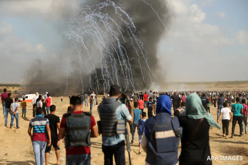 Palestinian protesters gather during clashes with Israeli troops in tents protest where Palestinian demand the right to return to their homeland at the Israel-Gaza border, in east of Gaza City on June 29, 2018. Photo by...