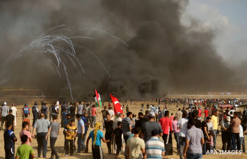 Palestinian protesters gather during clashes with Israeli troops in tents protest where Palestinian demand the right to return to their homeland at the Israel-Gaza border, in east of Gaza City on June 29, 2018. Photo by...