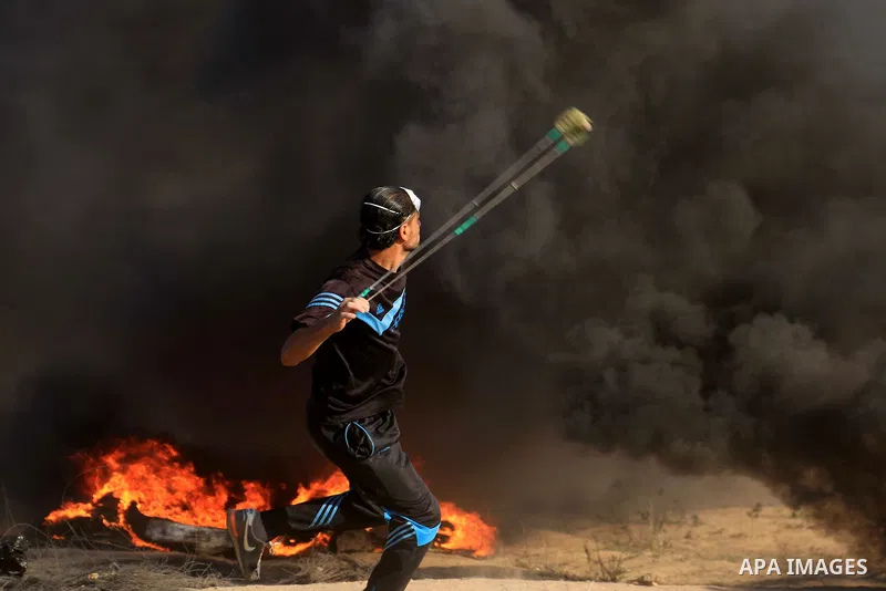 Palestinian protesters gather during clashes with Israeli troops in tents protest where Palestinian demand the right to return to their homeland at the Israel-Gaza border, in al-Bureij in the center of Gaza Strip on June...