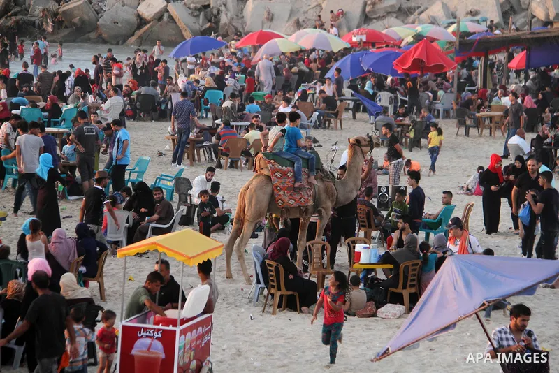 Palestinians enjoy their time at the sea coast of Gaza City June 29, 2018. Photo by Mahmoud Ajour
