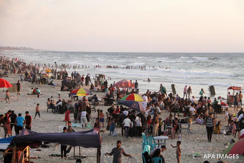 Palestinians enjoy their time at the sea coast of Gaza City June 29, 2018. Photo by Mahmoud Ajour