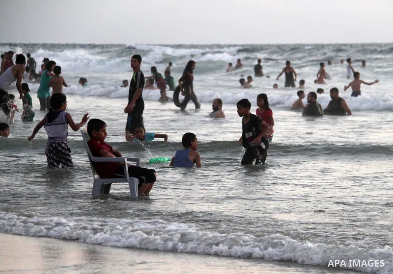 Palestinians swim to cool off in the Mediterranean Sea off the coast of Gaza City June 29, 2018. Photo by Mahmoud Ajour