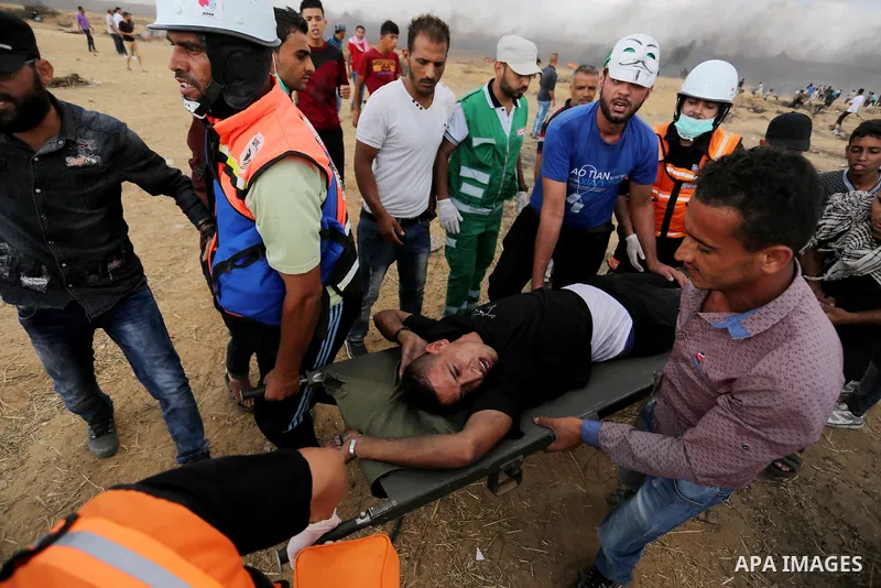 A wounded Palestinian protester is evacuated during clashes with Israeli troops in tents protest where Palestinian demand the right to return to their homeland at the Israel-Gaza border, in Khan Younis in the southern Ga...