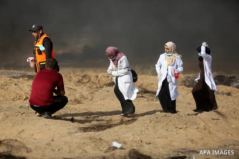 Palestinian protesters gather during clashes with Israeli troops in tents protest where Palestinian demand the right to return to their homeland at the Israel-Gaza border, in Khan Younis in the southern Gaza Strip on Jun...
