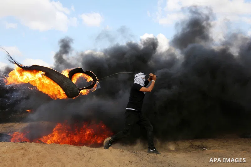 Palestinian protesters gather during clashes with Israeli troops in tents protest where Palestinian demand the right to return to their homeland at the Israel-Gaza border, in Khan Younis in the southern Gaza Strip on Jun...