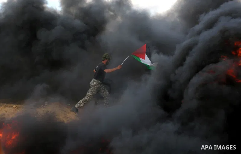 Palestinian protesters gather during clashes with Israeli troops in tents protest where Palestinian demand the right to return to their homeland at the Israel-Gaza border, in Khan Younis in the southern Gaza Strip on Jun...