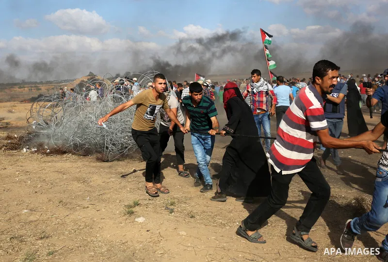 Palestinian protesters gather during clashes with Israeli troops in tents protest where Palestinian demand the right to return to their homeland at the Israel-Gaza border, in Khan Younis in the southern Gaza Strip on Jun...