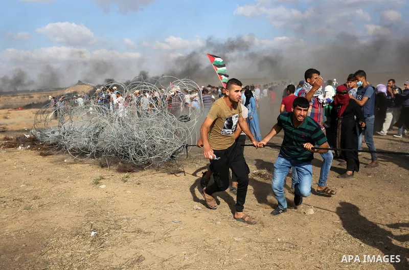 Palestinian protesters gather during clashes with Israeli troops in tents protest where Palestinian demand the right to return to their homeland at the Israel-Gaza border, in Khan Younis in the southern Gaza Strip on Jun...