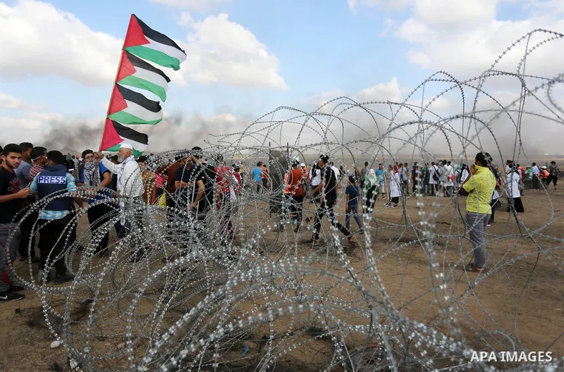 Palestinian protesters gather during clashes with Israeli troops in tents protest where Palestinian demand the right to return to their homeland at the Israel-Gaza border, in Khan Younis in the southern Gaza Strip on Jun...