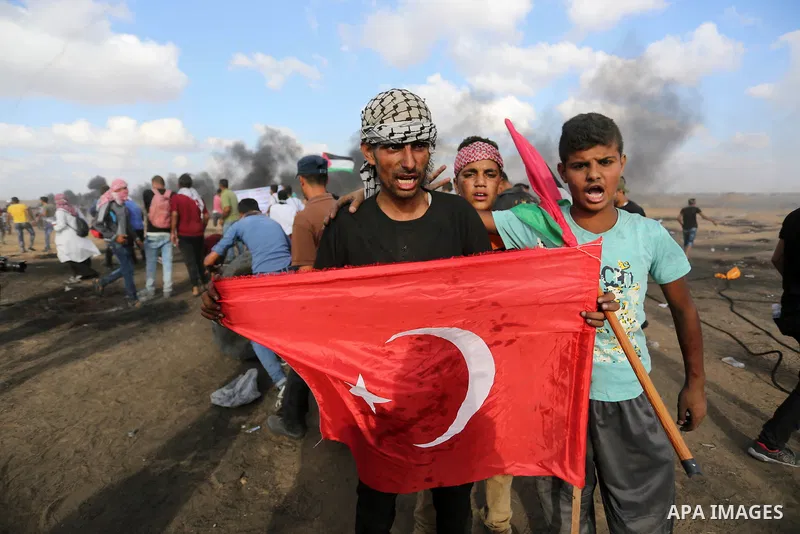 Palestinian protesters gather during clashes with Israeli troops in tents protest where Palestinian demand the right to return to their homeland at the Israel-Gaza border, in Khan Younis in the southern Gaza Strip on Jun...