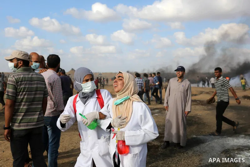 Palestinian protesters gather during clashes with Israeli troops in tents protest where Palestinian demand the right to return to their homeland at the Israel-Gaza border, in Khan Younis in the southern Gaza Strip on Jun...