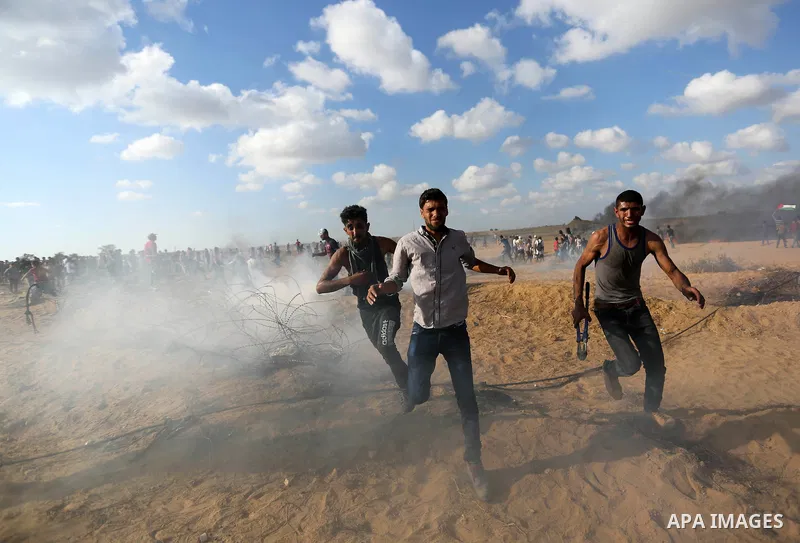 Palestinian protesters gather during clashes with Israeli troops in tents protest where Palestinian demand the right to return to their homeland at the Israel-Gaza border, in Khan Younis in the southern Gaza Strip on Jun...