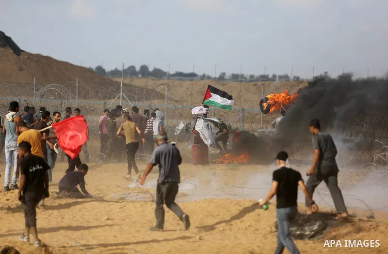 Palestinian protesters gather during clashes with Israeli troops in tents protest where Palestinian demand the right to return to their homeland at the Israel-Gaza border, in Khan Younis in the southern Gaza Strip on Jun...
