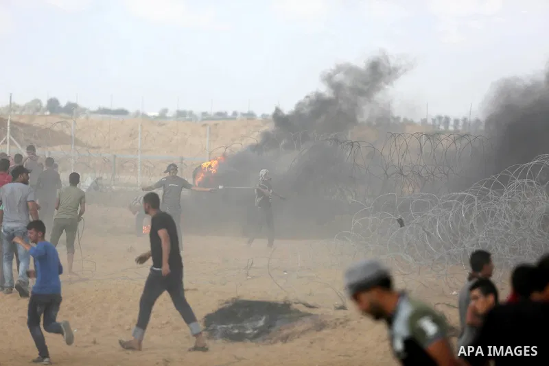 Palestinian protesters gather during clashes with Israeli troops in tents protest where Palestinian demand the right to return to their homeland at the Israel-Gaza border, in Khan Younis in the southern Gaza Strip on Jun...