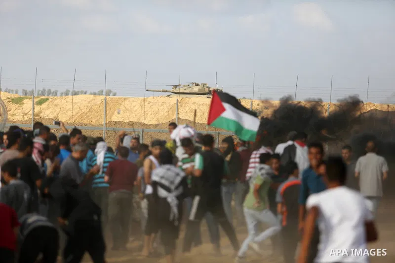 Palestinian protesters gather during clashes with Israeli troops in tents protest where Palestinian demand the right to return to their homeland at the Israel-Gaza border, in Khan Younis in the southern Gaza Strip on Jun...