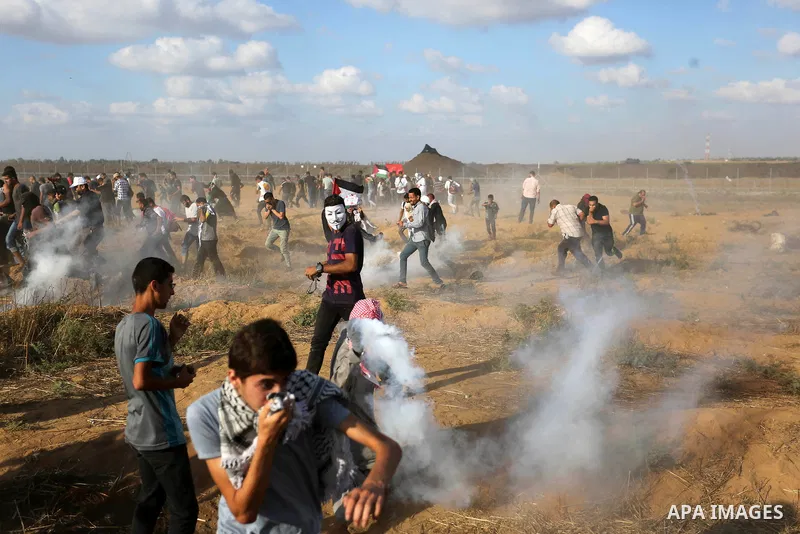 Palestinian protesters gather during clashes with Israeli troops in tents protest where Palestinian demand the right to return to their homeland at the Israel-Gaza border, in Khan Younis in the southern Gaza Strip on Jun...