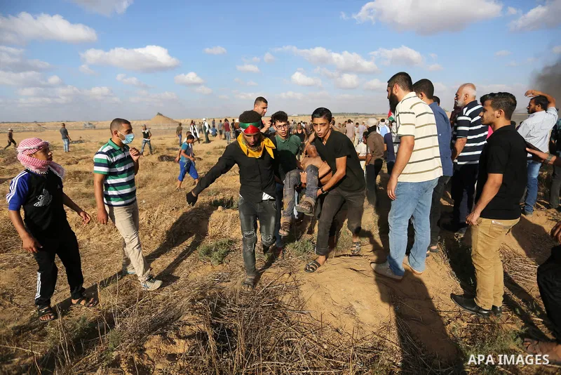 A wounded Palestinian protester is evacuated during clashes with Israeli troops in tents protest where Palestinian demand the right to return to their homeland at the Israel-Gaza border, in Khan Younis in the southern Ga...