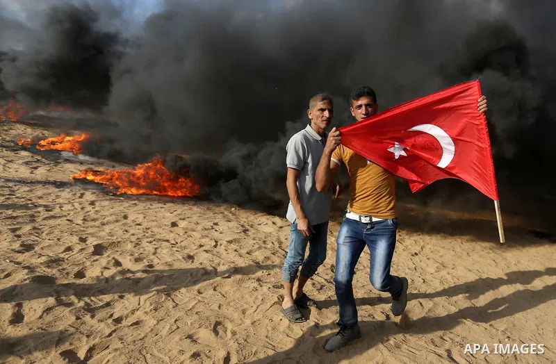 Palestinian protesters gather during clashes with Israeli troops in tents protest where Palestinian demand the right to return to their homeland at the Israel-Gaza border, in Khan Younis in the southern Gaza Strip on Jun...