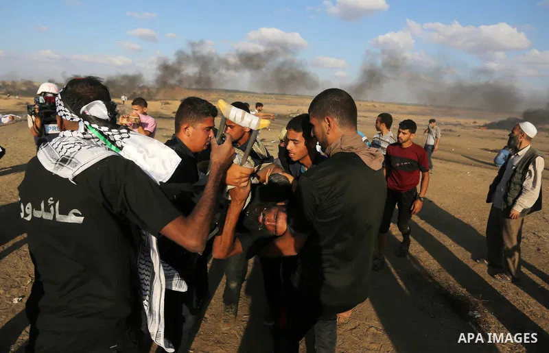 A wounded Palestinian protester is evacuated during clashes with Israeli troops in tents protest where Palestinian demand the right to return to their homeland at the Israel-Gaza border, in Khan Younis in the southern Ga...