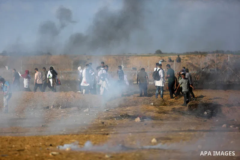 Palestinian protesters gather during clashes with Israeli troops in tents protest where Palestinian demand the right to return to their homeland at the Israel-Gaza border, in Khan Younis in the southern Gaza Strip on Jun...
