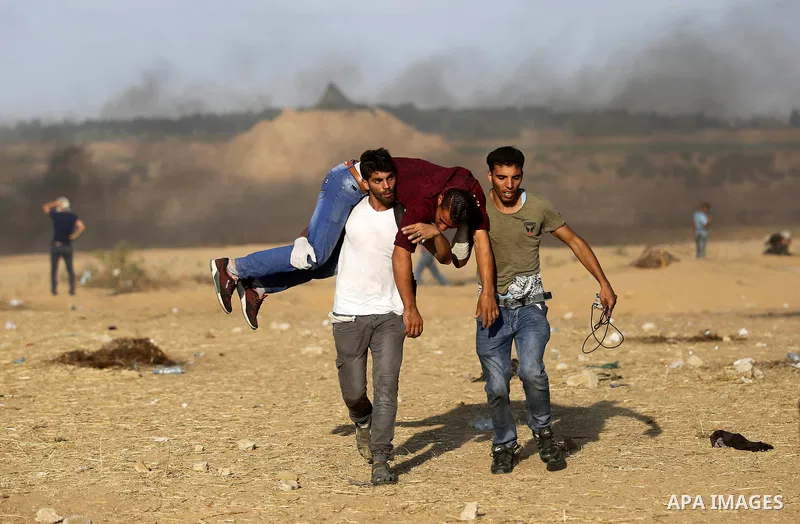 A wounded Palestinian protester is evacuated during clashes with Israeli troops in tents protest where Palestinian demand the right to return to their homeland at the Israel-Gaza border, in Khan Younis in the southern Ga...